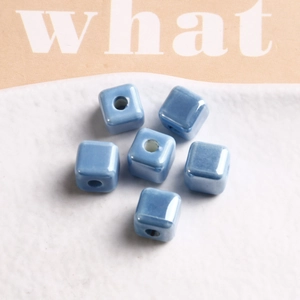 Macro detail of sky blue square ceramic beads with glossy glaze for DIY jewelry making