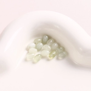 Macro shot of smooth 6mm oval green natural stone beads for DIY jewelry making