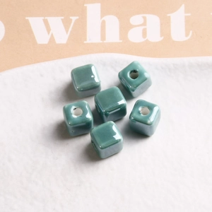 Macro shot of 9mm turquoise glazed ceramic cube beads with central holes for DIY jewelry