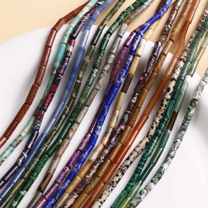 Close-up of polished natural stone tube beads in various colors for jewelry making