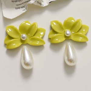 Glossy yellow flower earrings with teardrop pearls on a clean white background