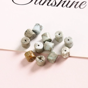 Close-up of 6mm natural stone oval spacer beads with natural textures for jewelry DIY