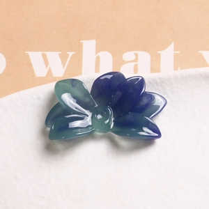 Macro shot of gradient blue lotus flower resin charms for DIY jewelry and hair accessories