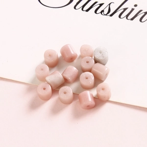 Macro detail of 6mm pink natural stone cylinder beads with center holes for DIY jewelry