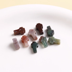 Detailed view of natural stone cross beads in various colors for DIY jewelry making