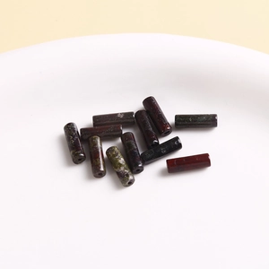 Close-up of mixed natural stone cylindrical beads with marbled texture for DIY jewelry