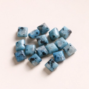 Κοντινό πλάνο τετράγωνων χαντρών K2 blue stone 8mm με μαύρα στίγματα για κατασκευές