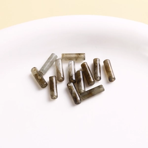 Macro shot of grey translucent labradorite cylinder beads with natural stone textures