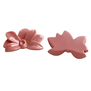 Flat lay of pink resin flower DIY charms showing front embossed petals and flat back