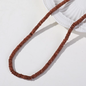 Macro detail of 6mm flat round brown goldstone beads for DIY jewelry making