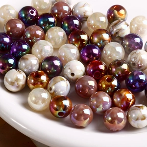 Macro shot of iridescent acrylic round beads with holes for DIY jewelry making