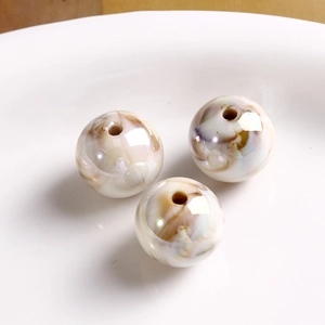 Macro detail of aurora acrylic round beads with marble texture for DIY jewelry making