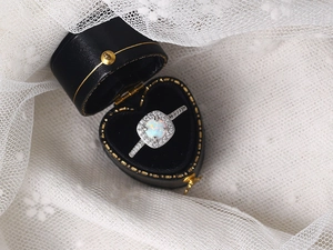 Classic white opal engagement ring with pavé zircons in a luxury heart-shaped box