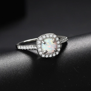 Classic silver-plated engagement ring with square opal center and halo zircon accents
