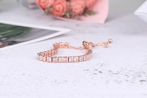 Detail of rose gold adjustable tennis bracelet featuring rectangular square zircons