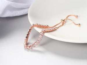 Detail view of adjustable tennis bracelet with 4mm square-cut cubic zirconia in rose gold