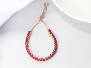 Close-up of adjustable rose gold tennis bracelet with square red zircon stones