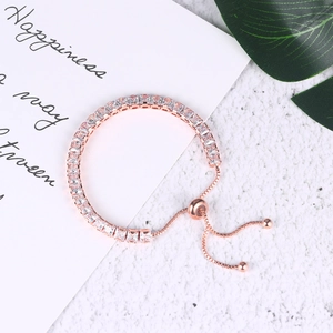 Adjustable rose gold tennis bracelet featuring rectangular clear cubic zirconia stones