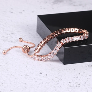 Rose gold adjustable tennis bracelet with square-cut cubic zirconia on marble background