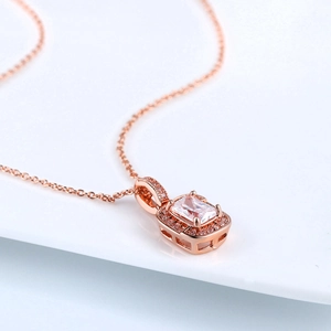 Detailed macro shot of rose gold necklace featuring a radiant cut square stone pendant