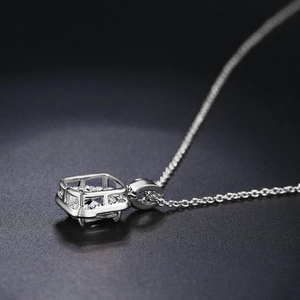 Macro side view of silver pendant necklace with square gemstone and pavé micro zircons