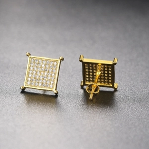 Macro view of square gold stud earrings showing micro-pave crystals and screw-back detail