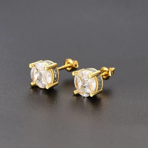 Macro view of four-prong round zircon earrings with secure screw-back closure in gold