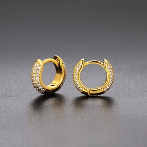 Detailed macro view of gold-plated hoop earrings with micro-pave cubic zirconia crystals
