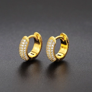 Close-up of gold-plated huggie hoop earrings with micro-pave cubic zirconia crystals