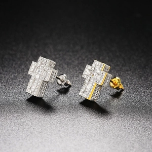 Macro shot of 3D hip hop cross earrings with full zircon inlay and two-tone plating