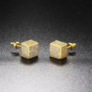 Macro shot of gold cube stud earrings featuring pave-set zircons and threaded screw backs