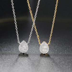 Macro detail of teardrop pave pendant necklaces in silver and gold plating
