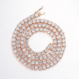 Macro detail of rose gold tennis chain with four-prong set round zirconia and safety clasp