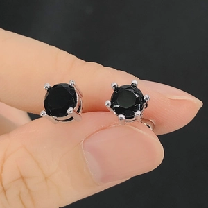 Macro shot of black cubic zirconia stud earrings with classic 4-prong and 6-prong settings