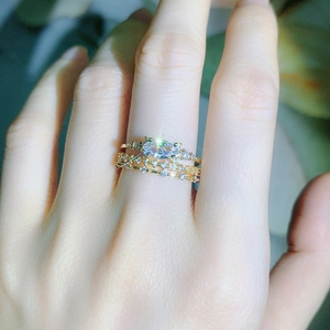 Detailed close-up of a three-piece gold stacking ring set with marquise-cut zircon on finger