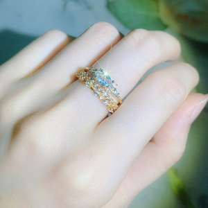 Close-up of three-piece gold ring set with marquise cut and pave-set zircons