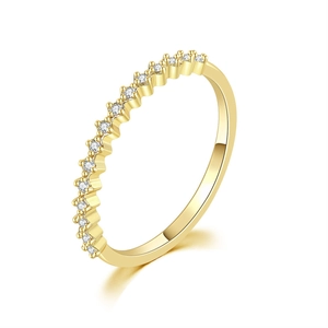 Macro shot of minimalist gold plated band ring with micro-paved white cubic zirconia