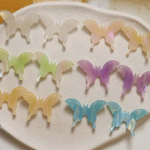 Close-up of translucent colorful acetate butterfly charms for DIY jewelry making