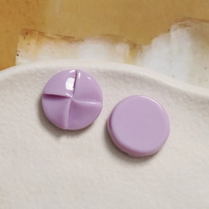 Macro detail of lavender resin windmill charms with spiral texture for DIY accessories