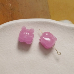 Roze konijn kralen van hars voor DIY sieraden in een witte keramieken schaal
