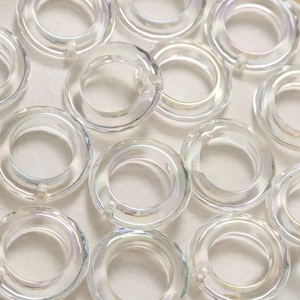 Macro shot of iridescent acrylic hollow rings with AB finish for DIY jewelry making