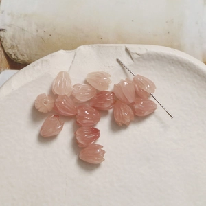 Macro shot of pale pink tulip bud beads showing fine texture and vertical hole design