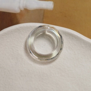 Macro shot of clear acrylic ripple hollow pendant for DIY jewelry making and crafts