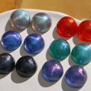 Macro view of 18mm iridescent starry acrylic cabochons for DIY jewelry making