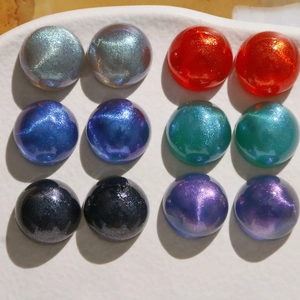 Macro shot of 18mm iridescent starry sky acrylic cabochons in a colorful 12-piece set