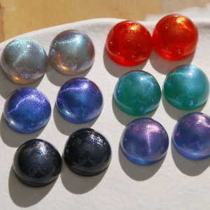 Macro shot of 18mm iridescent starry sky acrylic cabochons for DIY jewelry making