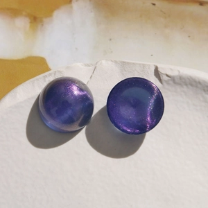 Close-up of 18mm purple iridescent galaxy acrylic cabochon for DIY jewelry making