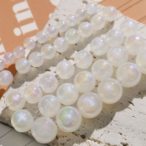 Macro view of various sizes of white iridescent faux pearl beads for DIY jewelry making