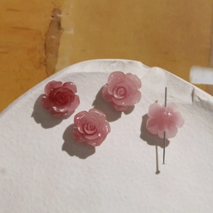 Detailed macro view of 16mm pink gradient rose flower beads with central hole for DIY jewelry