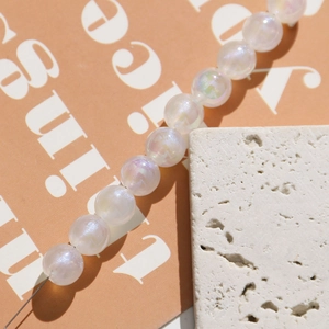 Detailed macro view of pearlescent AB mermaid acrylic beads for DIY jewelry making